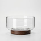Clear Glass Serving Bowl with Walnut Wood Stand in a nice white studio. 