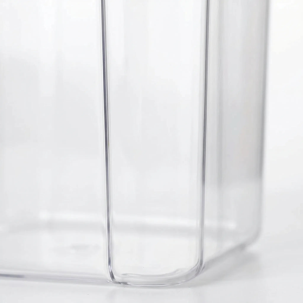 Clear Stackable Food Container detail on the side of it in a white studio. 