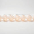 String of white paper lantern lights on a white background