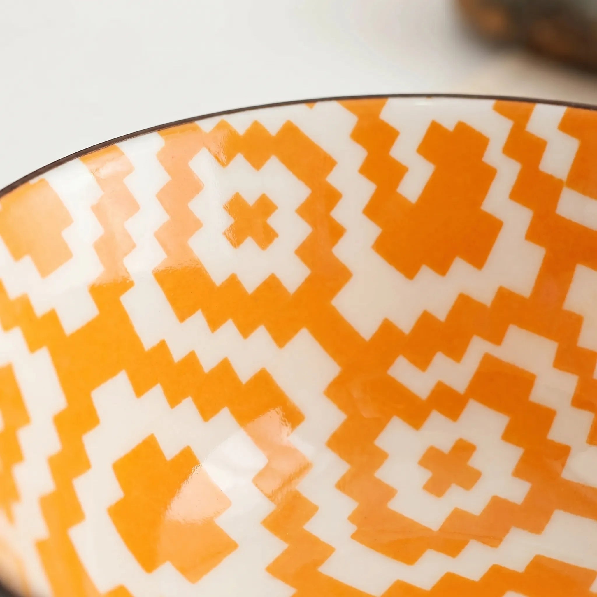 Patterned Ceramic Bowl in orange with a pattern. 