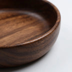 Details of the Solid Wood Serving Bowl – Natural Walnut In a nice white studio. 
