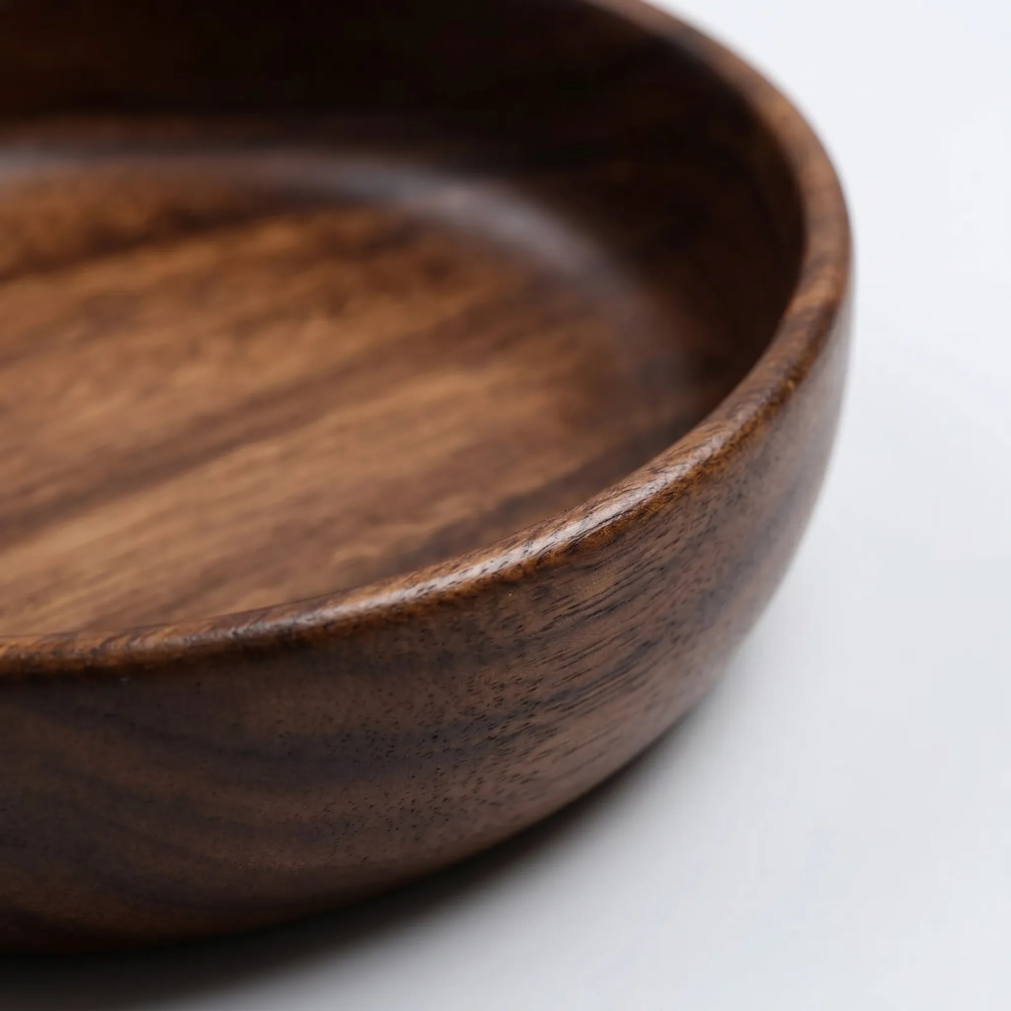 Details of the Solid Wood Serving Bowl – Natural Walnut In a nice white studio. 