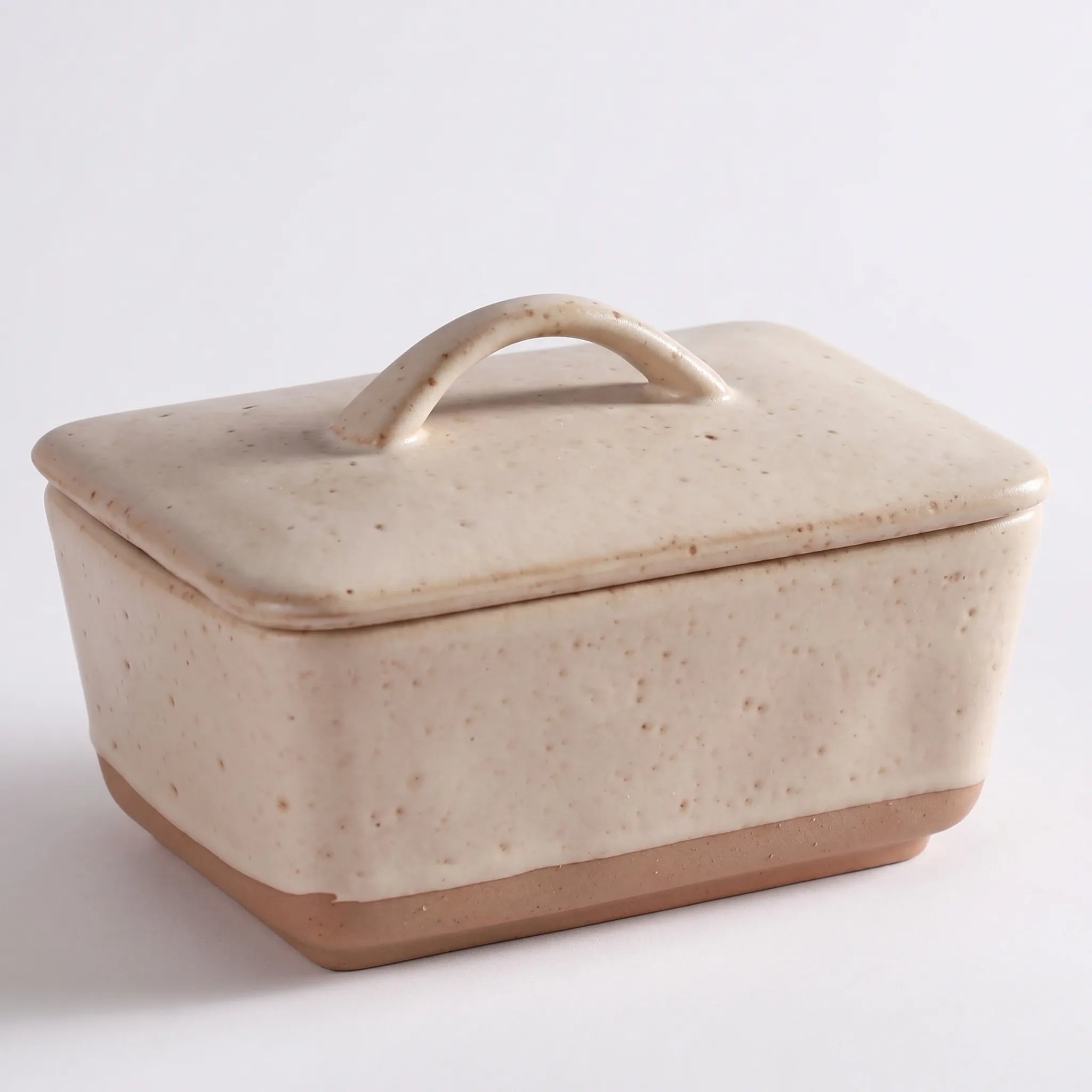 Speckled Stoneware Butter Dish – Cream with Lid in a nice white studio,