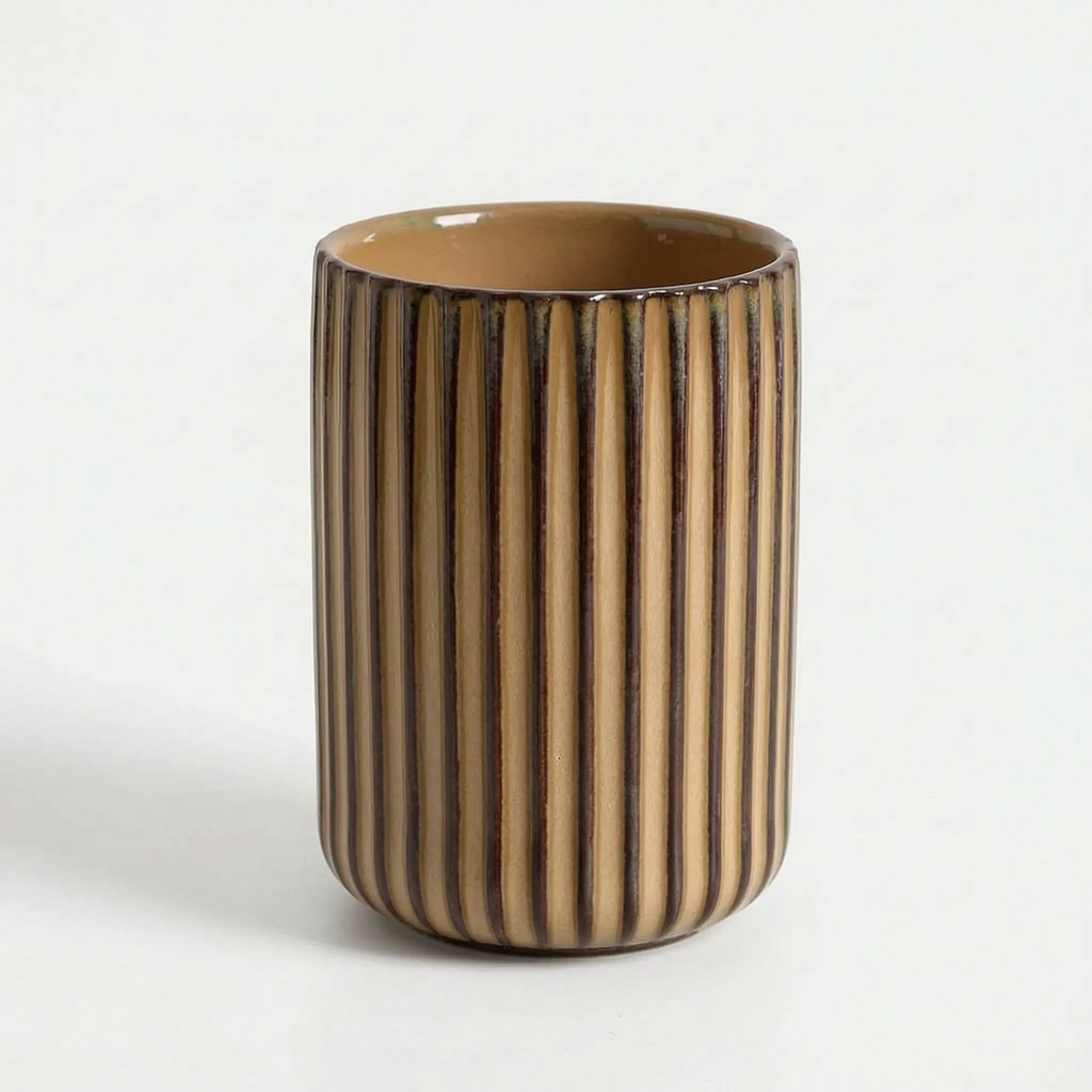 Cylindrical ceramic vase with striped pattern on a white background