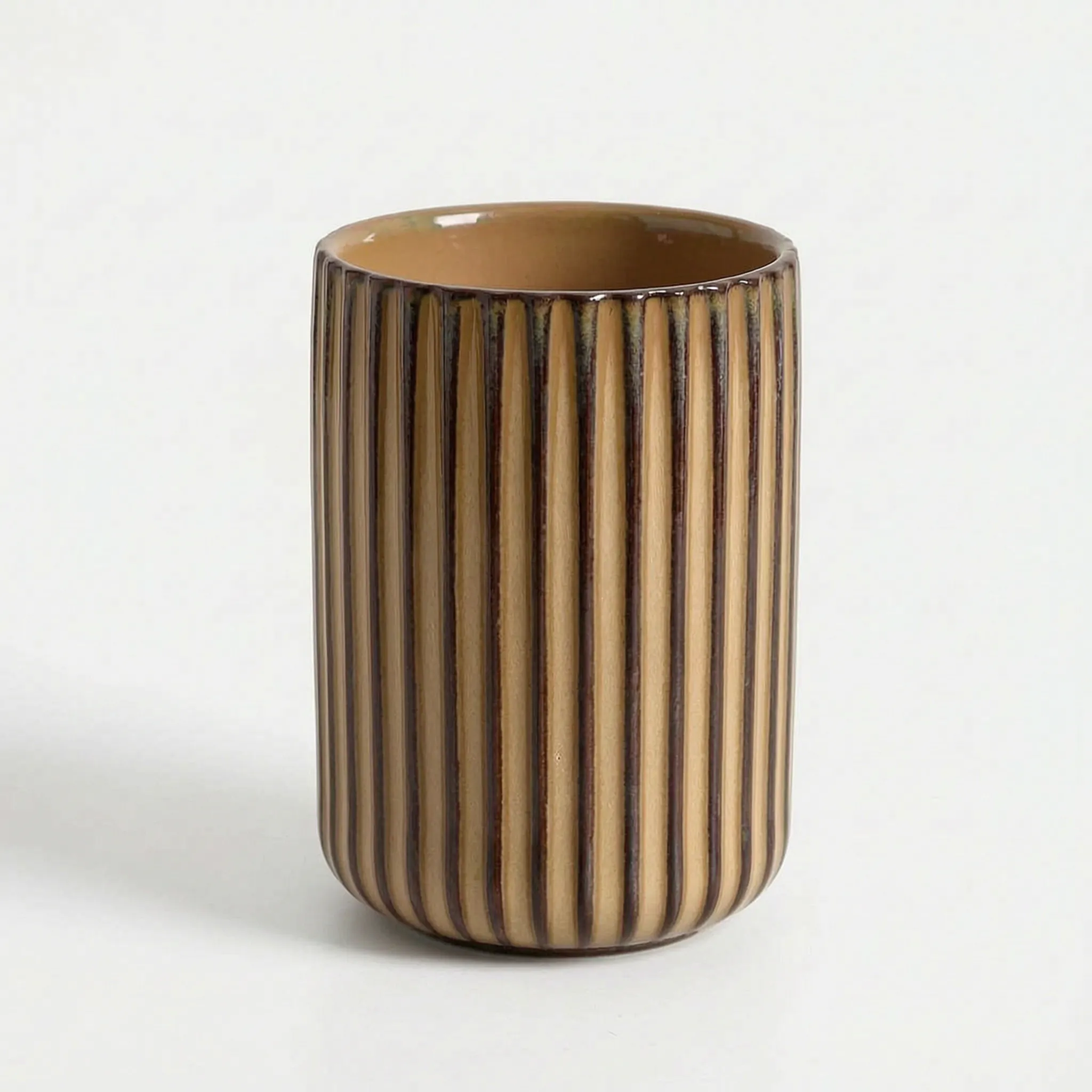 Cylindrical ceramic vase with striped pattern on a white background