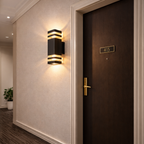 Modern wall sconce on a textured wall next to a door with a room number.