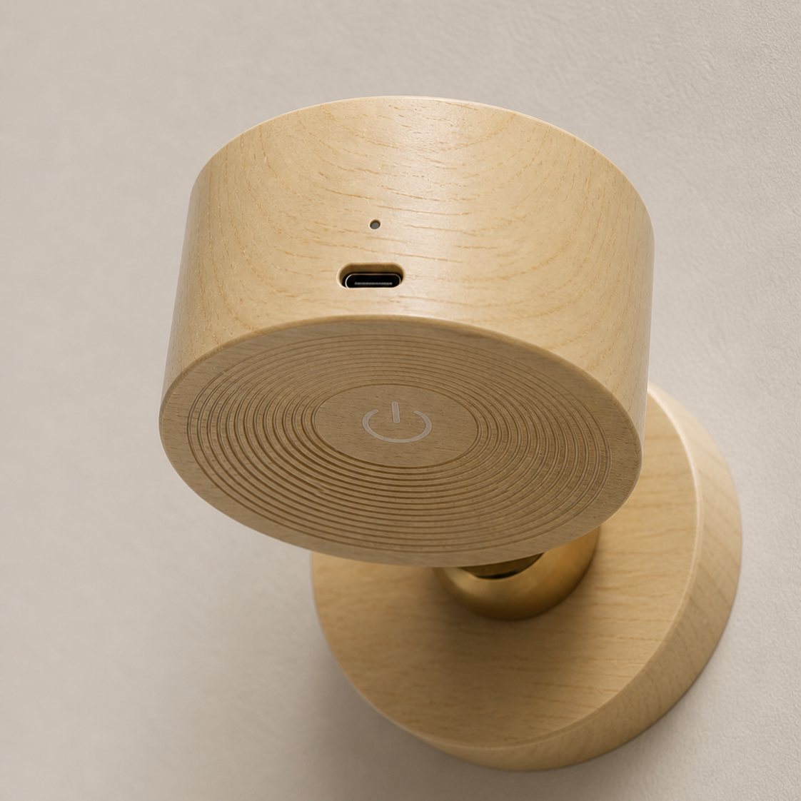 Wooden wall-mounted device with circular top and cylindrical base on a beige background