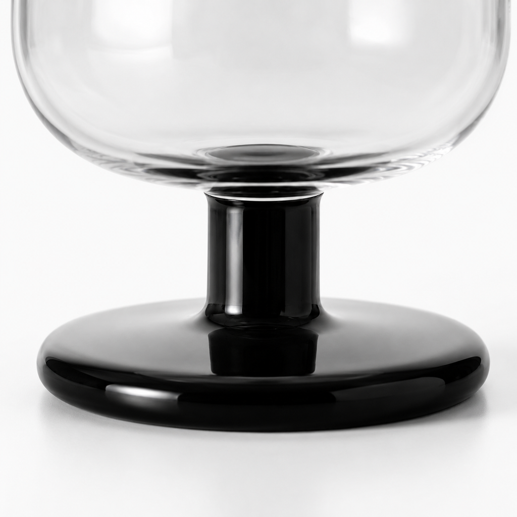 Clear glass bowl with black base on a white background