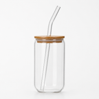 Clear glass tumbler with a wooden lid and glass straw on a white background