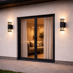 Modern sliding glass door with black frame and wall lights on a beige wall.