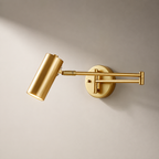 Gold wall-mounted lamp on a beige background