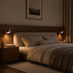 Cozy bedroom with a bed, nightstands, and wall lights in warm tones.
