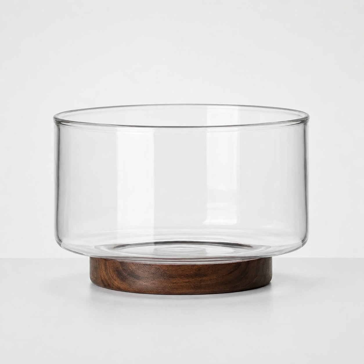 Clear Glass Serving Bowl with Walnut Wood Stand in a nice studio