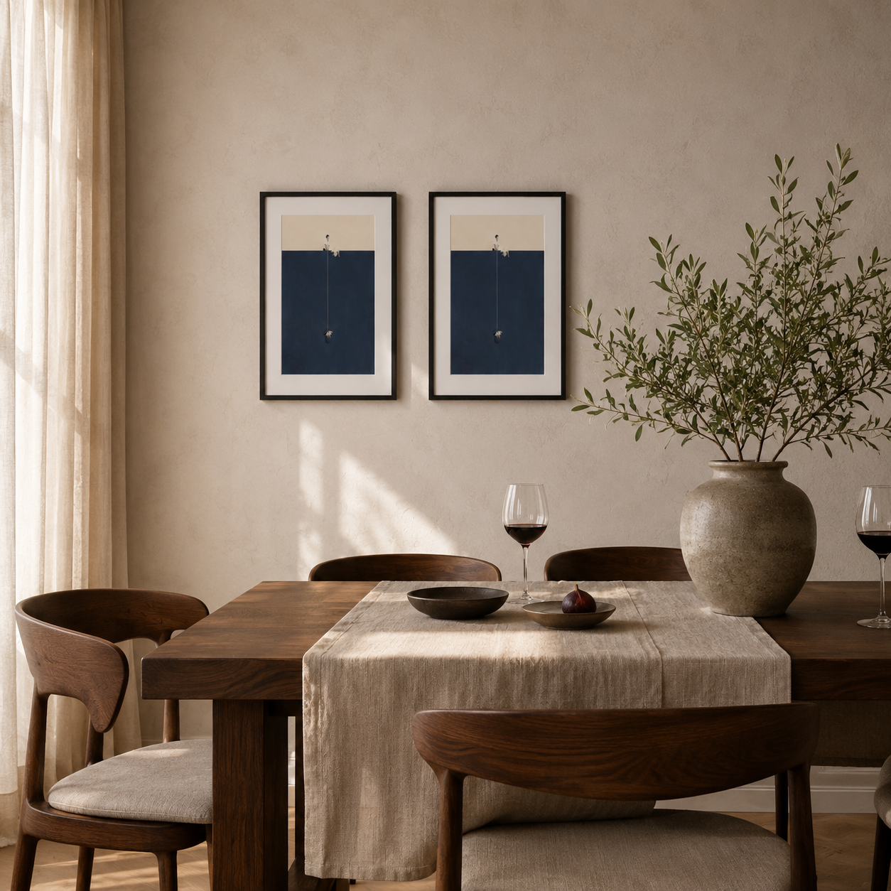 Two nice poster on the wall behind a modern dining room table.