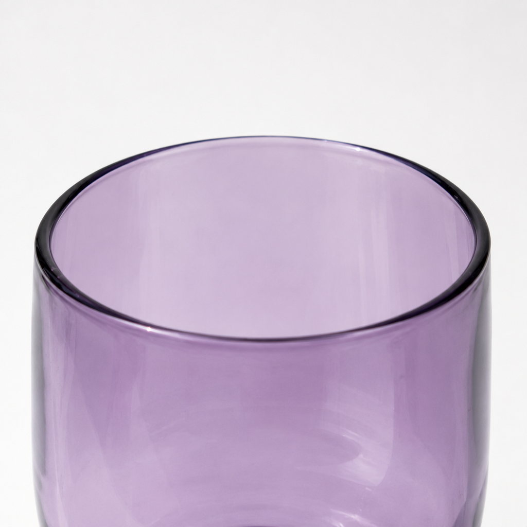 Purple glass tumbler on a white background