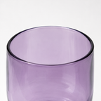 Purple glass tumbler on a white background