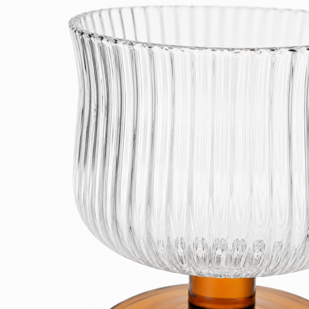 Clear glass vase with ribbed design on a white background
