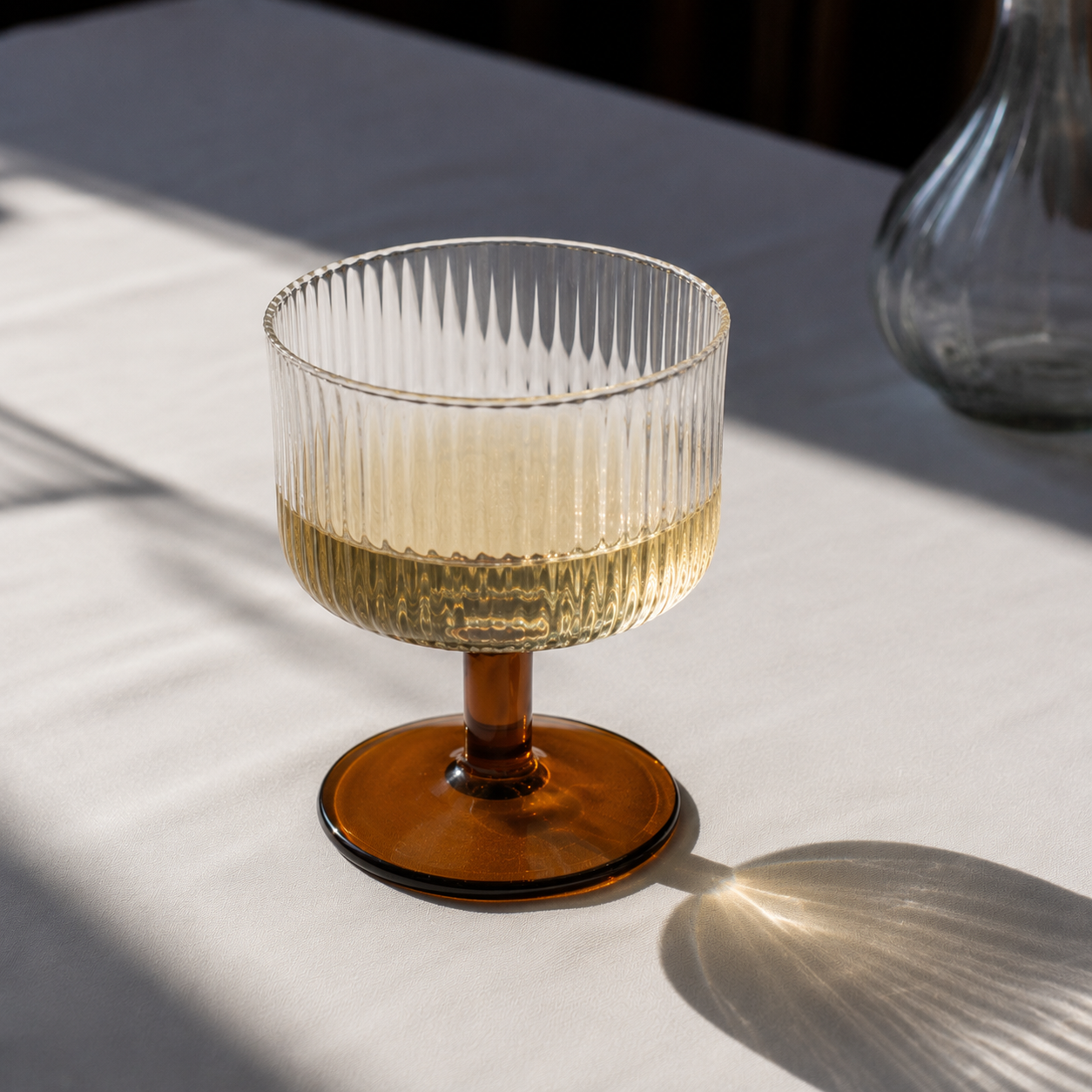 Glass with wooden base on a light surface