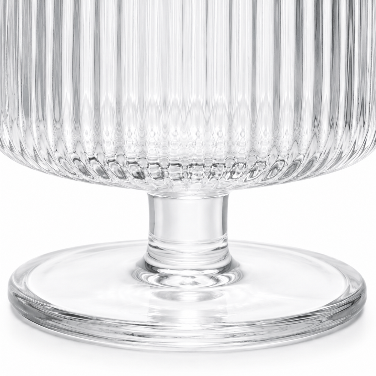 Clear glass pedestal bowl with textured design on a white background