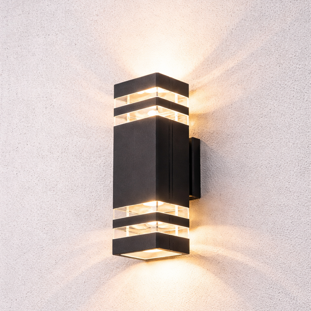 Modern black wall-mounted light fixture on a textured white wall