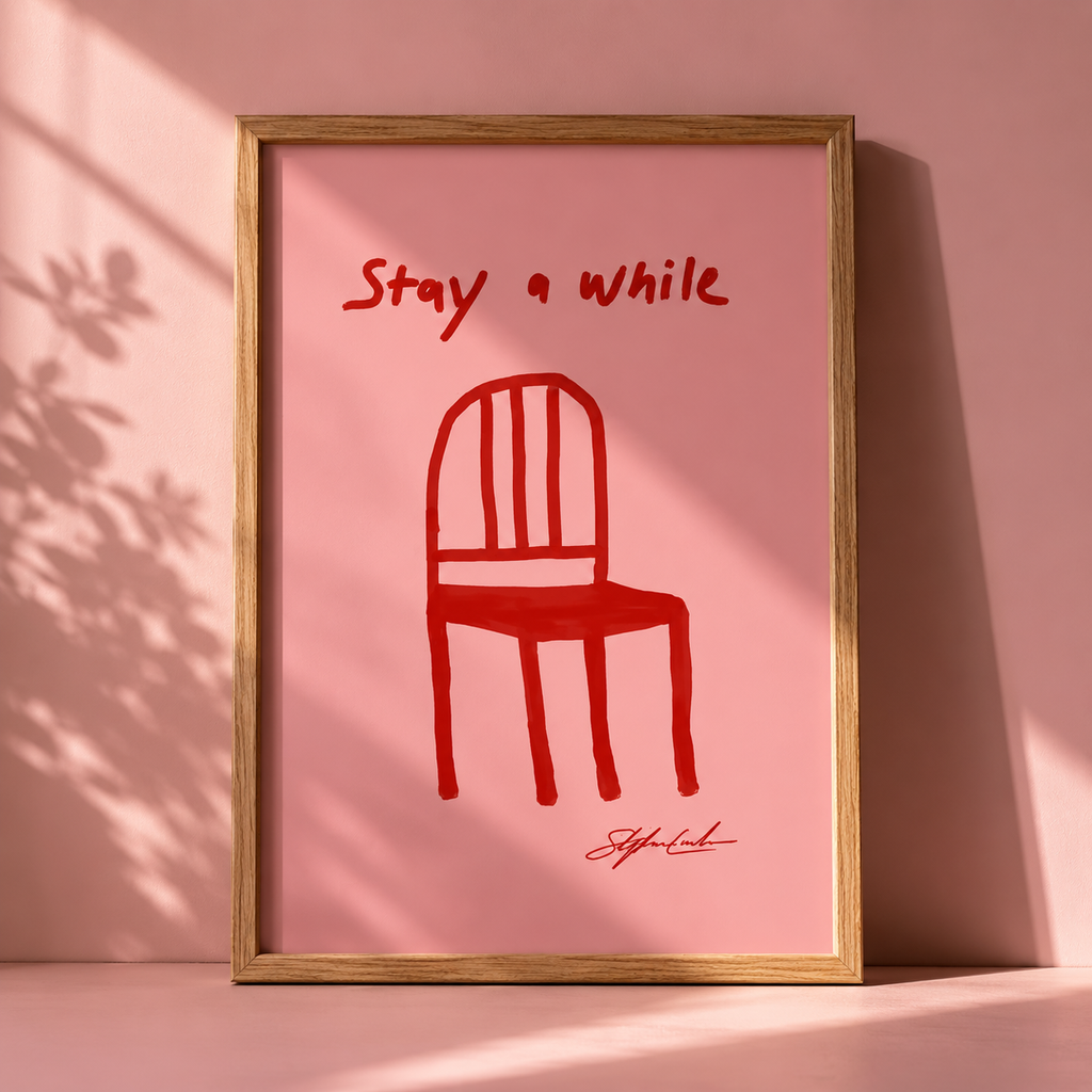 Red Chair Stay A While Print in a freame with a pink background. 