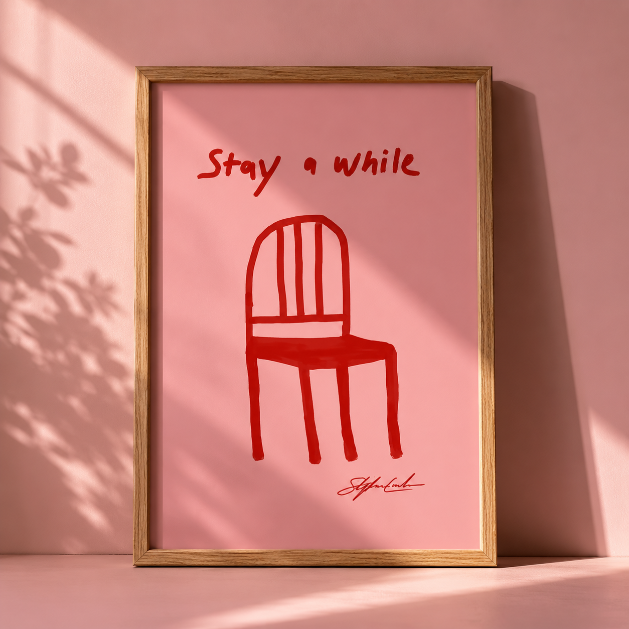 Red Chair Stay A While Print in a freame with a pink background. 