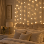 Bedroom with string lights on the walls and bed, creating a warm and cozy atmosphere.