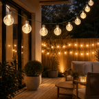 String lights illuminating a patio area with seating and plants.