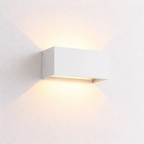 Modern wall-mounted light fixture on a white wall