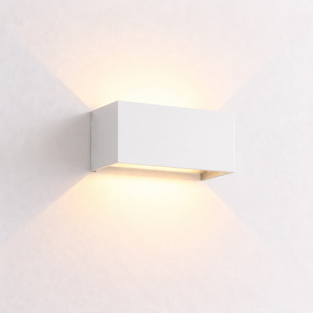 Modern wall-mounted light fixture on a white wall