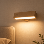 Wooden wall light fixture on a beige wall with a soft glow, next to a bed.